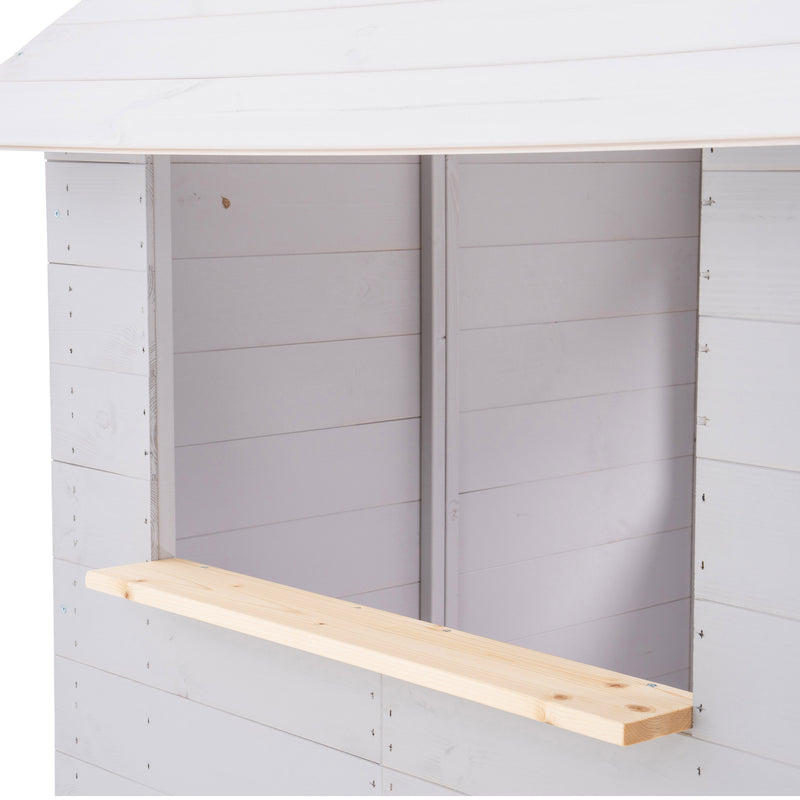 Détail de la fenêtre latérale d’une maisonnette en bois avec comptoir extérieur.